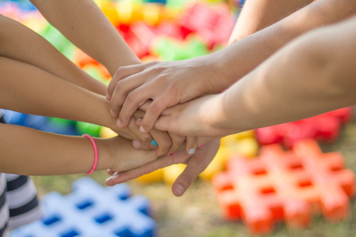 dark skin hands in a circle unity teamwork